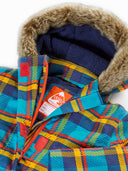 Close-up of a children's hooded jacket with a multicolor plaid pattern in blue, yellow, and red, featuring a brown faux-fur trimmed hood and a navy fleece lining. A visible orange and white Frugi brand tag is attached near the collar.